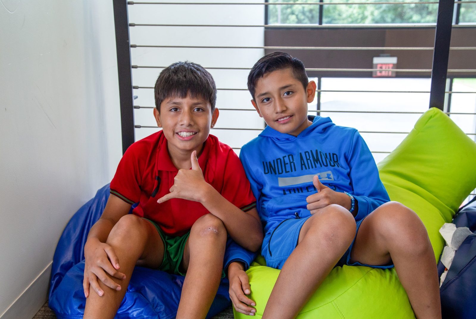Two students sitting on beanbag chairs