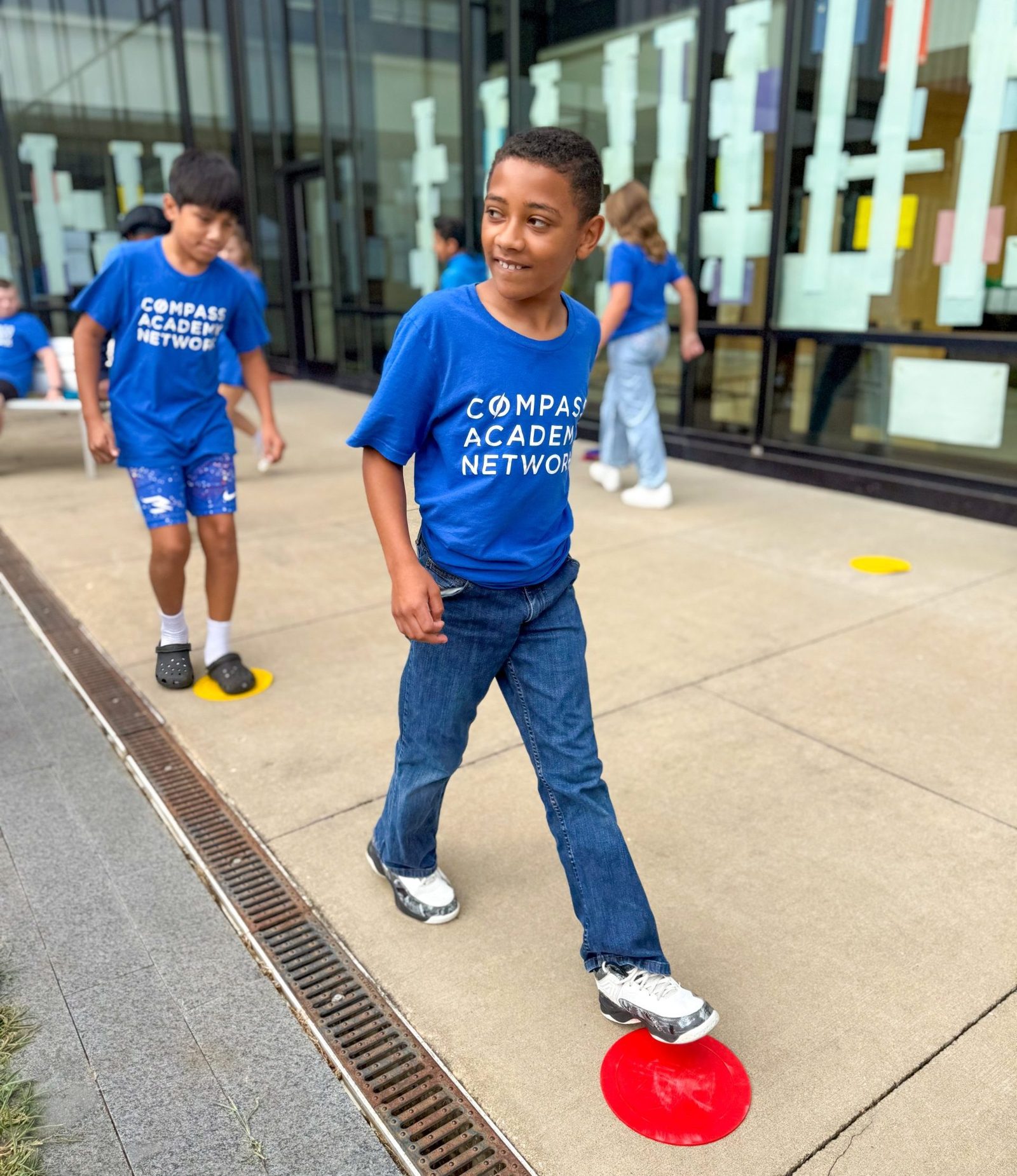 Students playing a game on the sidewalk