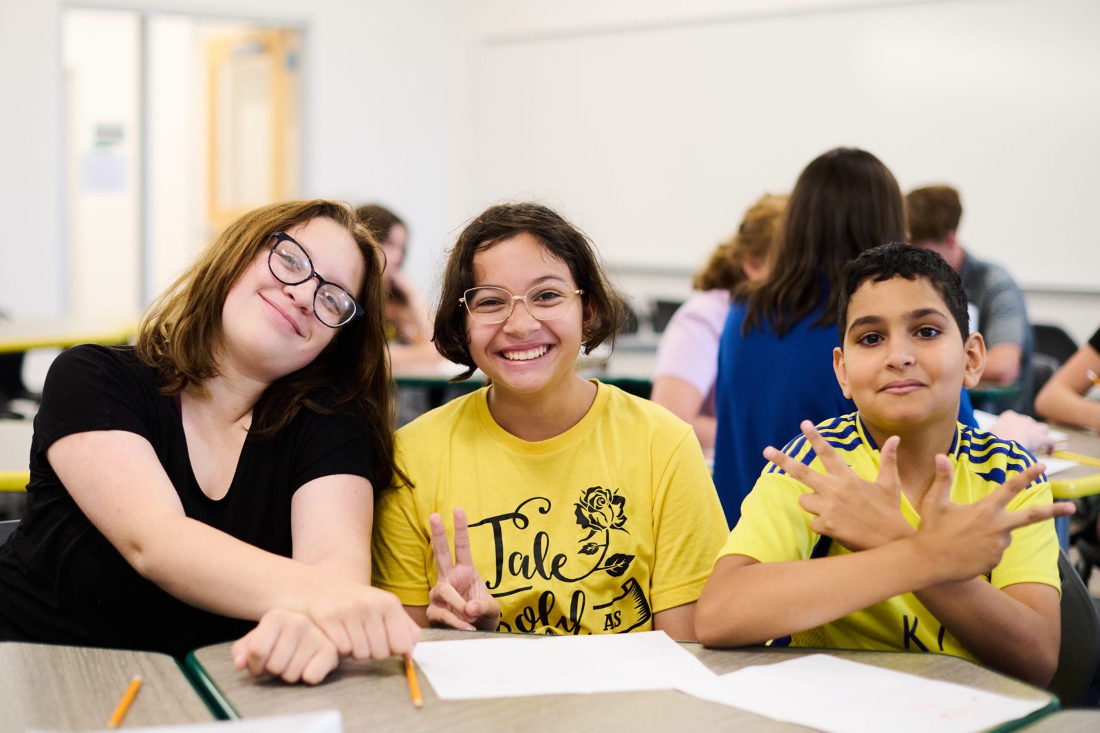 A student sitting with Compass Academy Network teacher